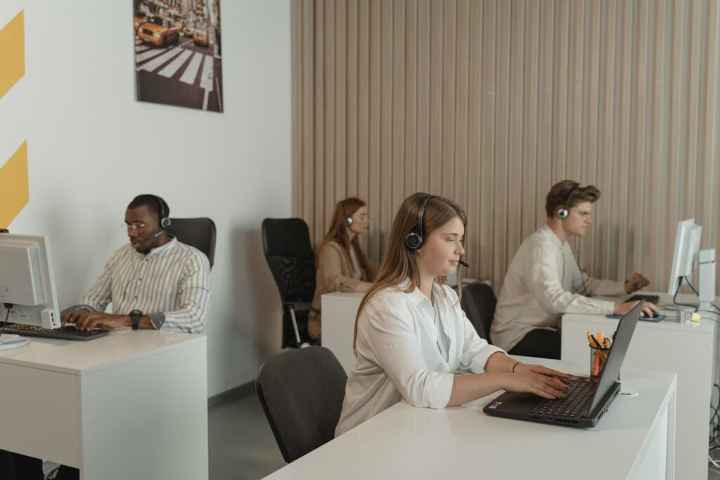 four-people-working-in-call-center-office-5453909 Four People Working in Call Center Office